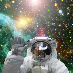 Astronaut waves. The elements of this image furnished by NASA.