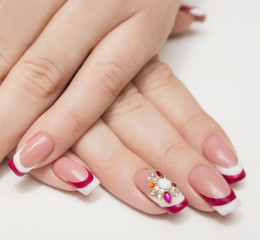 Closeup photo of a beautiful female hands with red nails