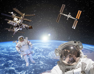 Astronaut, space stations and sunrise on the backdrop. The elements of this image furnished by NASA.
