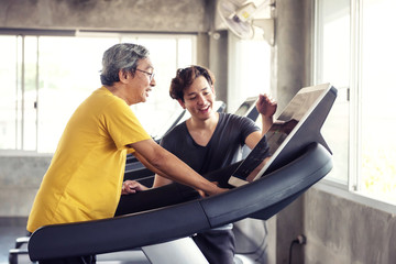 Old man run on treadmill with grandson