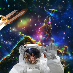 Astronaut posing. Rocket on the backdrop. The elements of this image furnished by NASA.