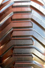 Close up new tractor wheel. Large unused truck tire.