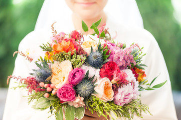 Beautiful wedding bouquet in bride hands before wedding ceremony
