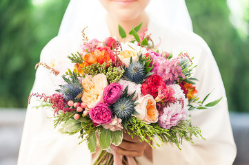 Beautiful wedding bouquet in bride hands before wedding ceremony