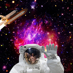Astronaut posing. Rocket on the backdrop. The elements of this image furnished by NASA.