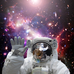 Fototapeta na wymiar Astronaut waves. The elements of this image furnished by NASA.