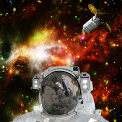 Obraz na płótnie Canvas Astronaut posing against galaxies and stars. Outer space. The elements of this image furnished by NASA.