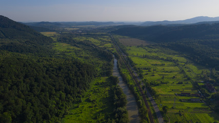 Aerial view of the Carpathian mountains. Natural background with geometric pattern - beige and red...
