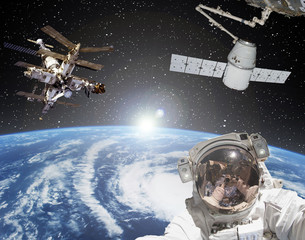 Fototapeta na wymiar Astronaut, spaceships and sunrise on the backdrop. The elements of this image furnished by NASA.
