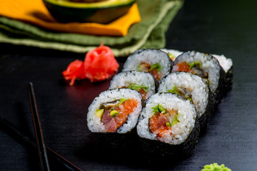 Japanese sushi and rolls on a black background