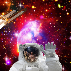 Obraz na płótnie Canvas Astronaut posing. Rocket on the backdrop. The elements of this image furnished by NASA.