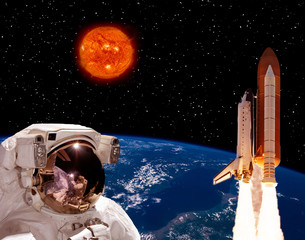 Astronaut staring on the rocket that flying from earth. Big sun against stars. The elements of this...