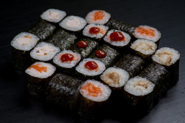 Japanese sushi and rolls on a black background