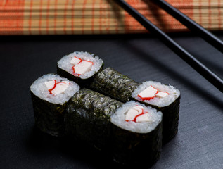 Japanese sushi and rolls on a black background