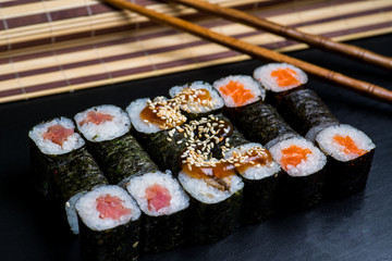 Japanese sushi and rolls on a black background