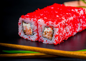 Japanese sushi and rolls on a black background
