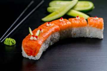 Japanese sushi and rolls on a black background