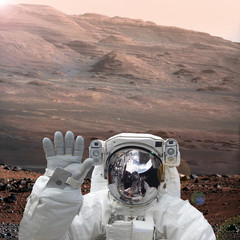 Spaceman walks on the planet Mars. The elements of this image furnished by NASA.
