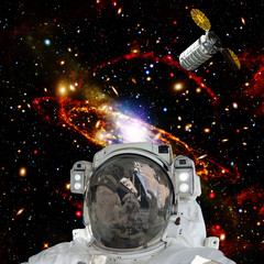 Astronaut posing against galaxies and stars. Outer space. The elements of this image furnished by...