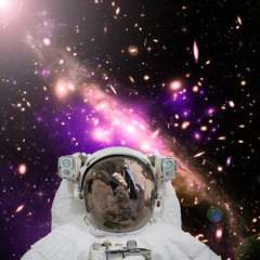 Closeup of astronaut. Galaxy on the background. The elements of this image furnished by NASA.
