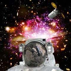 Fototapeta na wymiar Astronaut posing against galaxies and stars. Outer space. The elements of this image furnished by NASA.