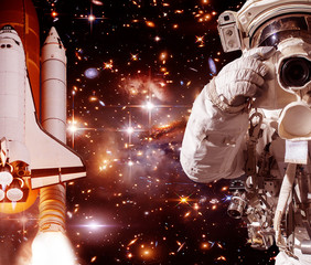 Astronaut with camera and rocket (shuttle). The elements of this image furnished by NASA.