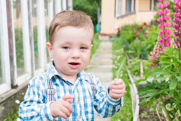 little boy in suspenders, in the village