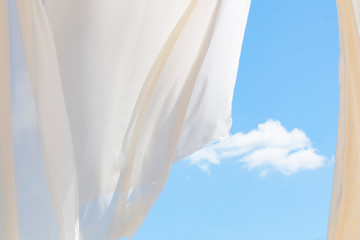 close up view  with white curtain lace, blue cloudy sky