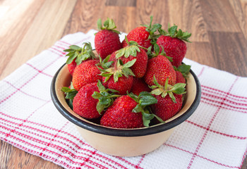 Fresh ripe organic red sweet strawberries in a cup on the table