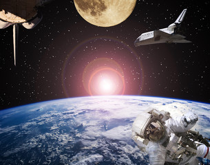 Astronaut, spaceships and moon. Sunrise on the backdrop. The elements of this image furnished by...