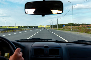 view of the road through the front window of the car