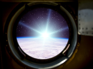 Gorgeous view of sunrise. Window of spaceship. Elements of this image furnished by NASA.