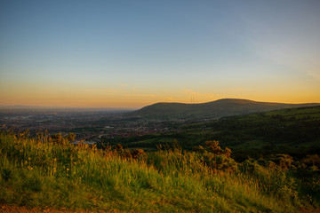 Fototapeta na wymiar Colorful sunset at Cave Hill Country Park Belfast, Northern Ireland. Aerial view on City and hills 