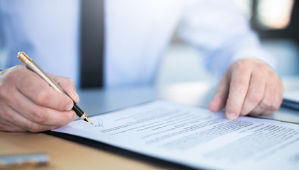Business man signing contract, making a deal.