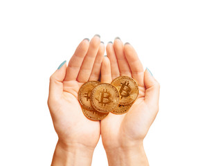 Many gold bitcoins coins in female hands.