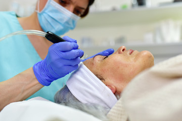 Obraz na płótnie Canvas Skin care. Woman receiving facial beauty treatment. Facial therapy. Anti-aging procedures.