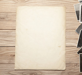 Old photo, blank template for picture, mock-up. Wooden background.