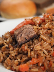 Rice with Vegetables and Meat in a plate on wooden table