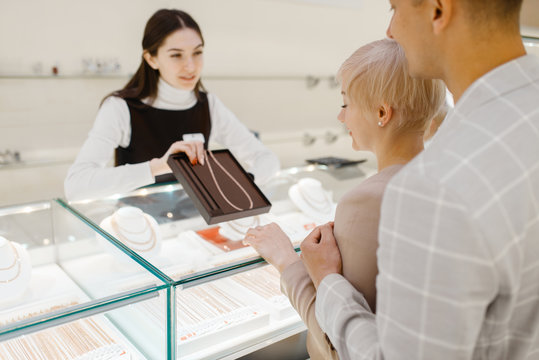 Love Couple Buying Gold Necklace In Jewelry Store