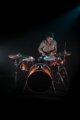 musician playing drums, black background and beautiful soft light