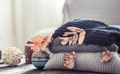 Stack of knitted sweaters on a wooden table