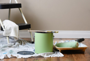 Equipment for painting and interior room with copy space on a blank wall.