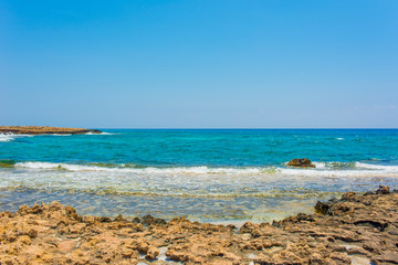 Fototapeta na wymiar pristine seascapes with crystal clear blue water and yellow rocks in Ayia Napa, Cyprus