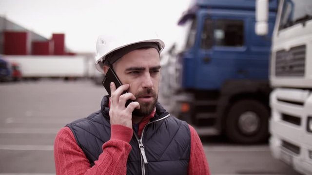 Trailer driver with hard hat and safety vest. Close up portrait of worker