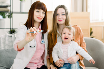 Digital thermometer to measure the heat temperature of a sick child. Baby fever concept. Doctor,...