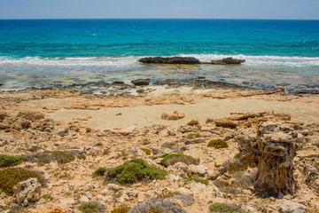 Fototapeta na wymiar pristine seascapes with crystal clear blue water and yellow rocks in Ayia Napa, Cyprus