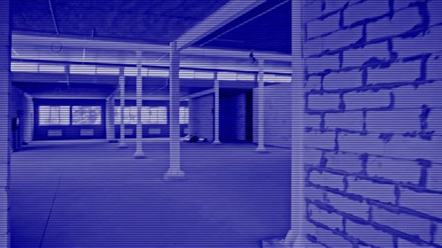 The hero of a computer game is looking for a target in an unfinished building. Search with night vision device. Bad signal, distortion. Simulation of computer video game shooter. Arcade, strategy POV
