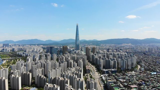 Aerial view cityscape of Seoul with Lotte tower at Jamsil. View of Seoul with river and mountain. Seoul downtown city skyline, Aerial view of Seoul, South Korea