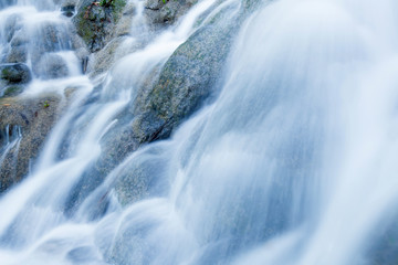 Obraz na płótnie Canvas Close of tropical waterfall pouring on limestone.