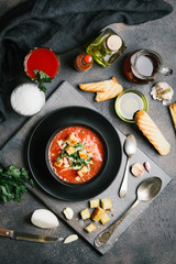 Traditional spanish gazpacho made from fresh farm produce on a dark background. top view